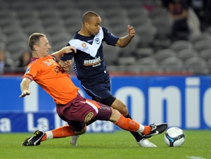 Melbourne Victory's Archie Thompson is challenged by Brisbane Roar's Craig Moore, during their round 9 of the 2009 A-League season, being played at Ethihad Stadium in Melbourne, Saturday, Oct. 3, 2009.(AAP Image/Joe Castro)