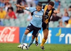 Sydney FC's Steve Corica (left) is tackled by Matthew Crowell of the Central Coast Mariners FC in their round 19 match in Sydney on Wednesday, Dec. 23, 2009. (AAP Image/Paul Miller) 